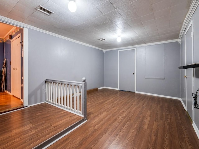 basement featuring hardwood / wood-style floors and ornamental molding