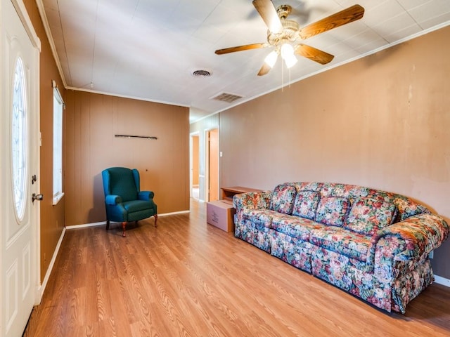 living room with crown molding, hardwood / wood-style flooring, and ceiling fan