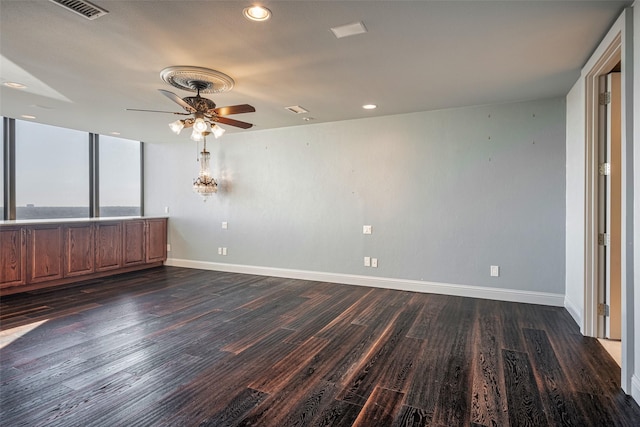 empty room featuring ceiling fan and dark hardwood / wood-style flooring