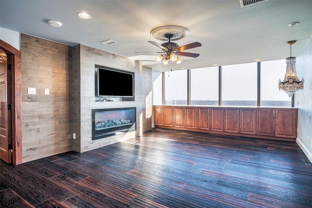 unfurnished living room with a tile fireplace, ceiling fan, and dark hardwood / wood-style flooring