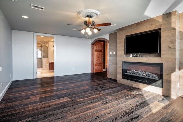 living room with ceiling fan, a tile fireplace, and dark hardwood / wood-style floors