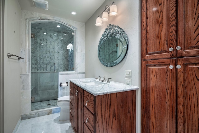 bathroom featuring vanity, toilet, and a shower with door