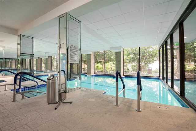 view of swimming pool featuring an indoor hot tub