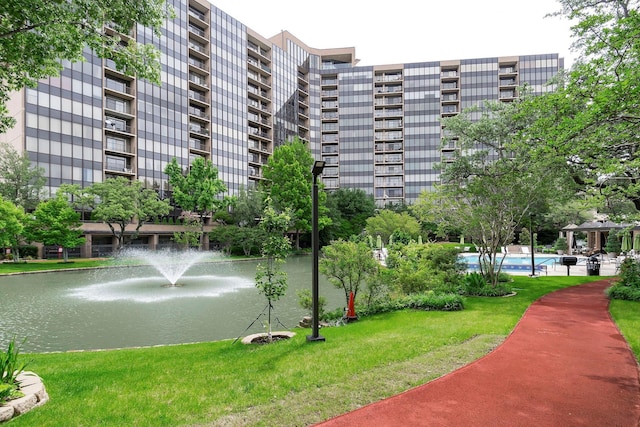 view of home's community featuring a water view and a yard