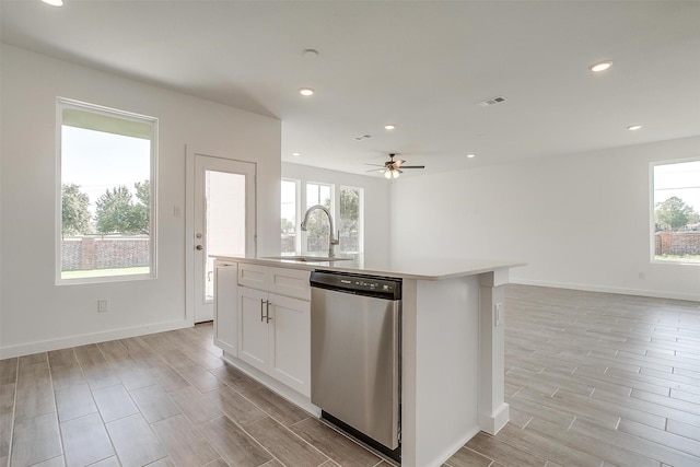 kitchen featuring white cabinets, dishwasher, an island with sink, sink, and ceiling fan