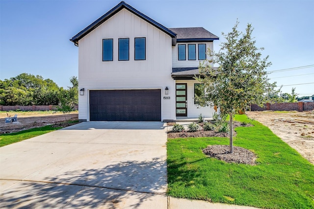 view of front of home featuring a front yard and a garage