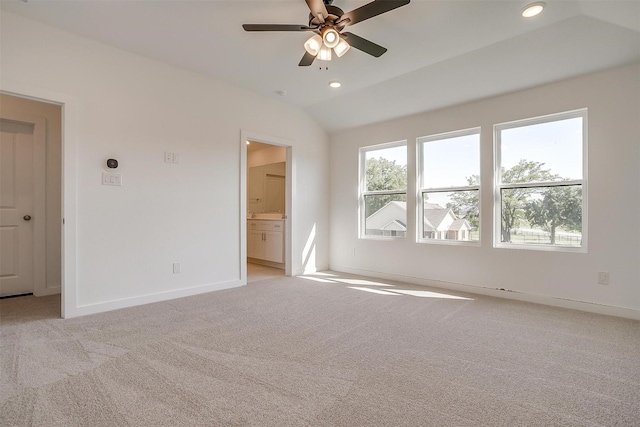 carpeted spare room with ceiling fan and lofted ceiling