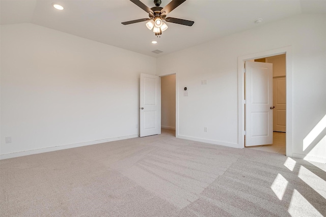 carpeted empty room featuring ceiling fan and lofted ceiling