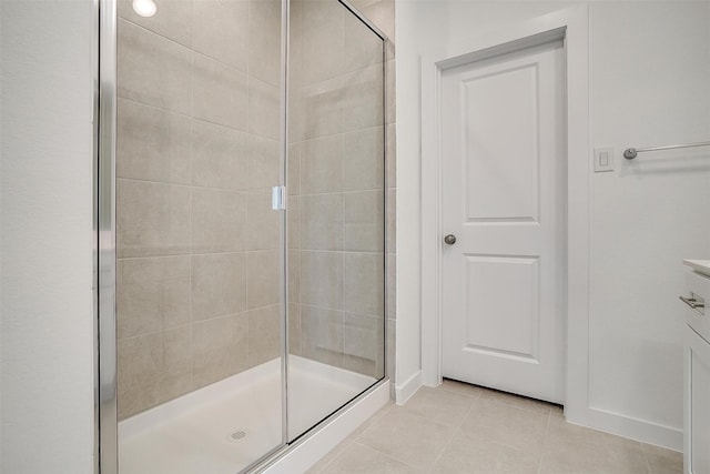 bathroom featuring a shower with shower door and tile patterned floors