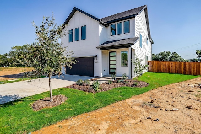 view of front of property featuring a garage and a front yard