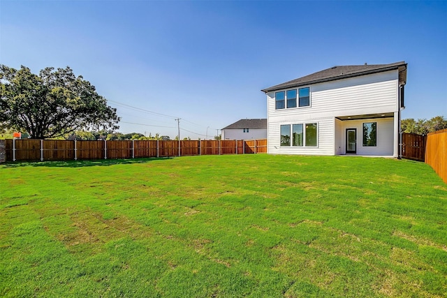 rear view of house with a yard