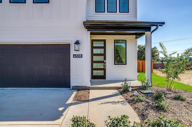 view of exterior entry with a garage