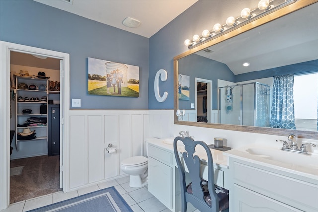 bathroom featuring tile patterned floors, toilet, walk in shower, and vanity