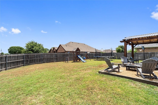 view of yard with a playground, an outdoor fire pit, and a trampoline