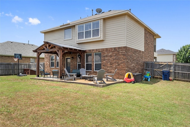 back of property with a fire pit, a patio area, and a yard