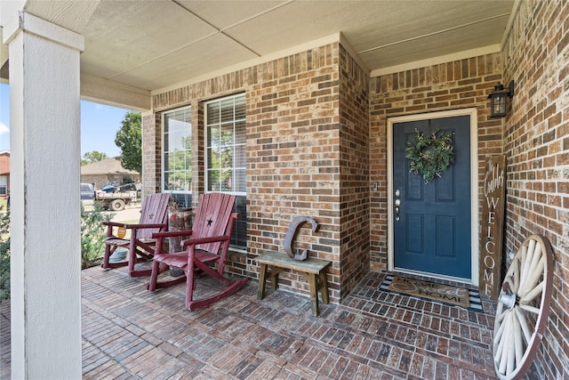 view of exterior entry featuring a porch