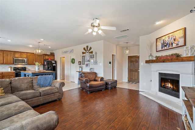 living room featuring ceiling fan and wood-type flooring