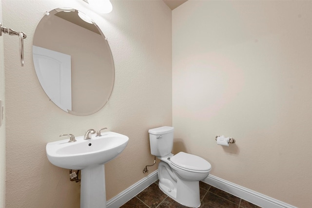 bathroom with sink, toilet, and tile patterned floors