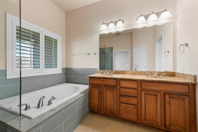 bathroom featuring independent shower and bath, tile patterned floors, and vanity