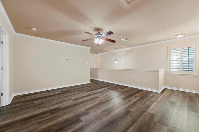 unfurnished room with ceiling fan, dark wood-type flooring, and crown molding