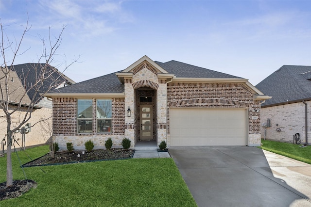 view of front of house featuring a garage and a front lawn