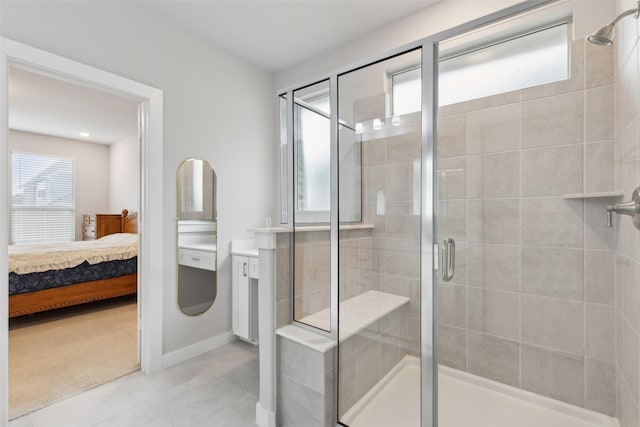 bathroom featuring a shower with door, tile patterned flooring, and vanity