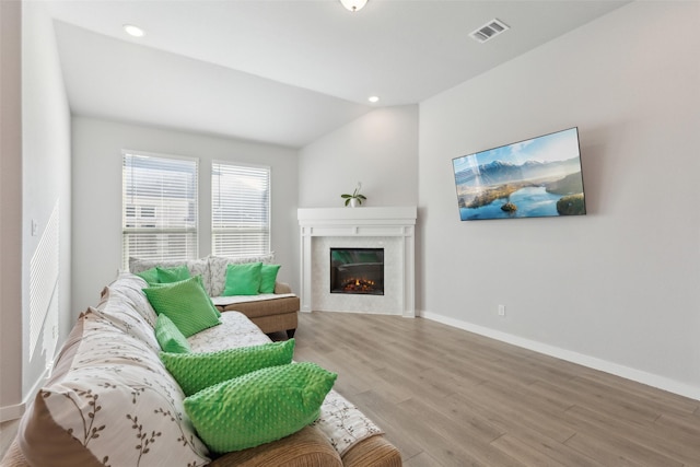 living room with vaulted ceiling and light hardwood / wood-style flooring