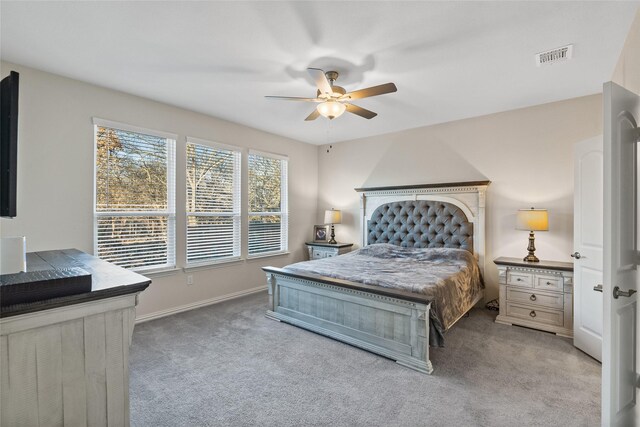 bedroom with ceiling fan and light carpet