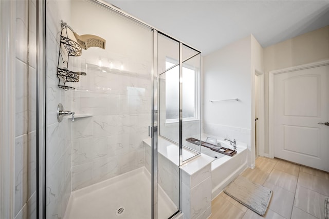 bathroom with shower with separate bathtub