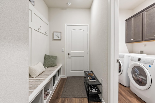 clothes washing area with dark hardwood / wood-style flooring, cabinets, and independent washer and dryer