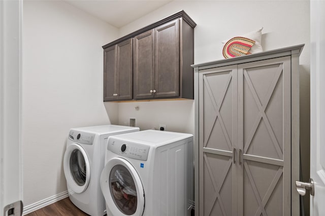 washroom with cabinets, dark hardwood / wood-style flooring, and independent washer and dryer