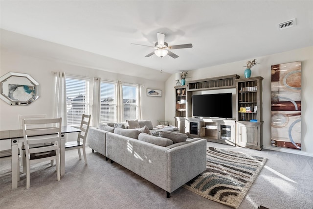 living room featuring vaulted ceiling, carpet floors, and ceiling fan