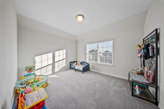 rec room with vaulted ceiling and carpet flooring