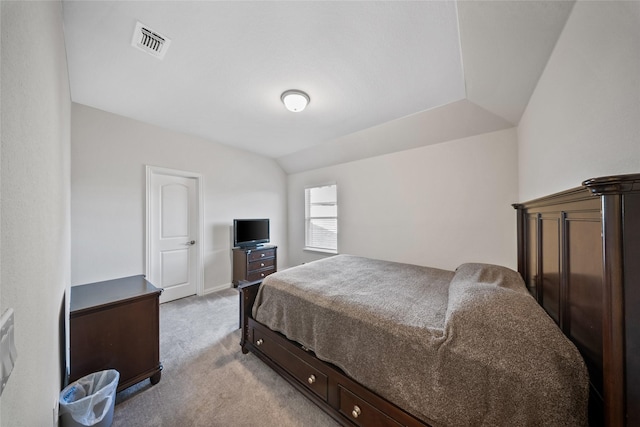 carpeted bedroom with lofted ceiling