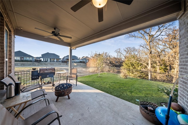 view of patio / terrace with ceiling fan and a fire pit