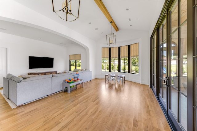 living room featuring beamed ceiling, high vaulted ceiling, light hardwood / wood-style floors, and a notable chandelier