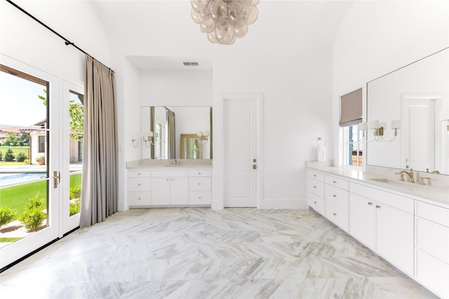 bathroom featuring vanity, a chandelier, and a high ceiling