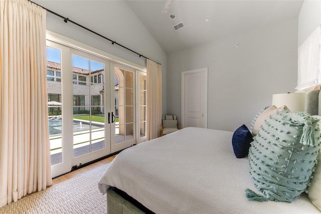 bedroom with french doors, lofted ceiling, and access to outside