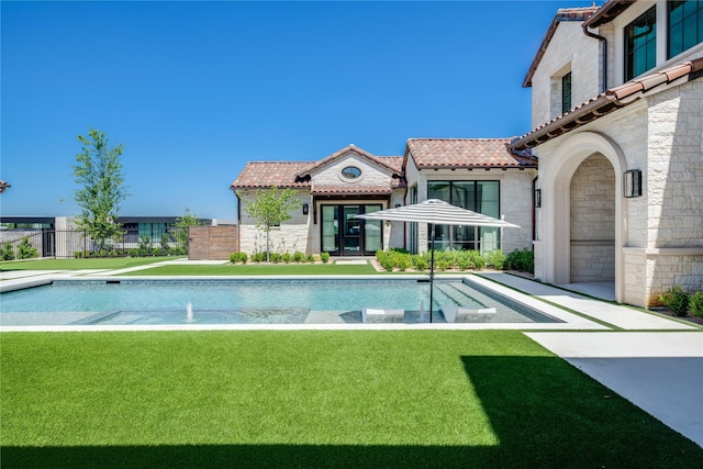 view of pool with a yard and pool water feature