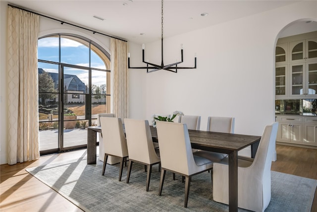 dining space featuring an inviting chandelier and light hardwood / wood-style floors