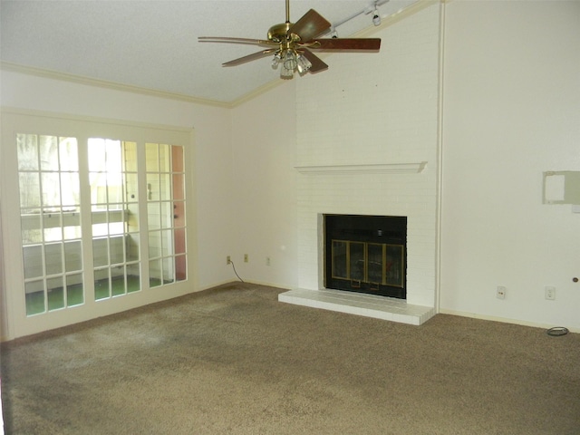 unfurnished living room featuring ornamental molding, vaulted ceiling, a brick fireplace, and carpet flooring