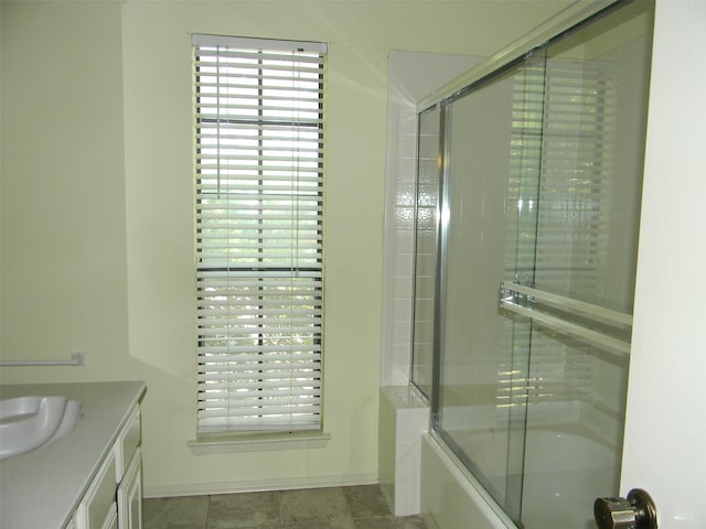 bathroom with vanity and enclosed tub / shower combo