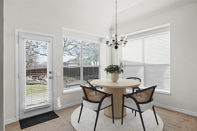 dining area with plenty of natural light, a notable chandelier, and light tile patterned flooring