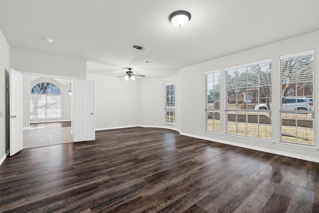 unfurnished living room with dark hardwood / wood-style floors and ceiling fan