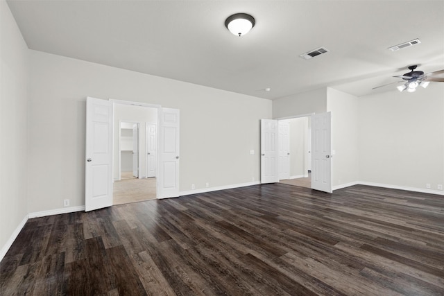 spare room featuring dark wood-type flooring and ceiling fan