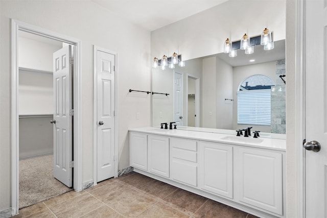 bathroom with vanity, a shower, and tile patterned flooring