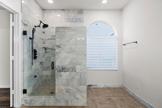 bathroom with tile patterned flooring and an enclosed shower