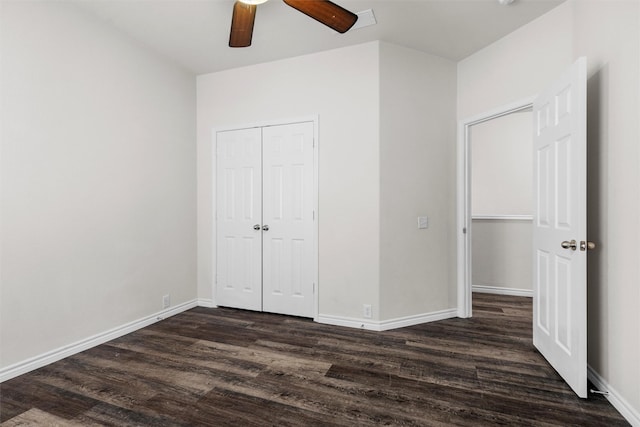 unfurnished bedroom with ceiling fan, dark hardwood / wood-style flooring, and a closet