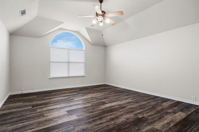 spare room featuring ceiling fan, dark wood-type flooring, and lofted ceiling