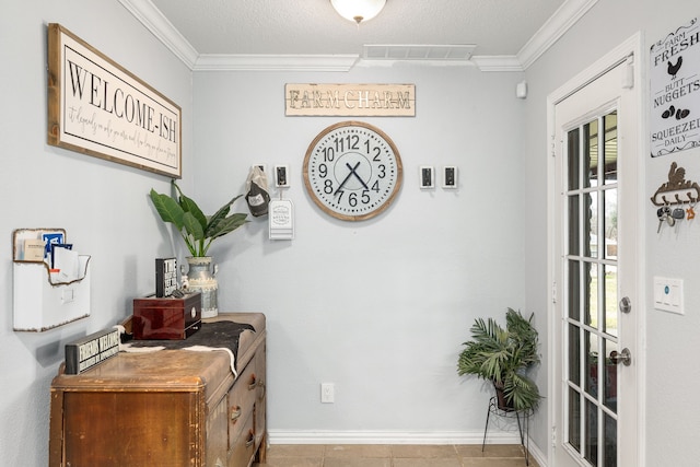 interior space with ornamental molding, a textured ceiling, and light tile patterned floors